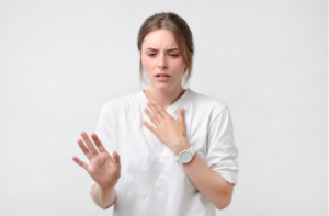  mujer con camiseta blanca que tiene dolor de garganta.